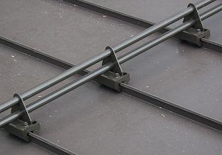 Ace-Clamp pipe-style snow fence system - dark bronze close-up