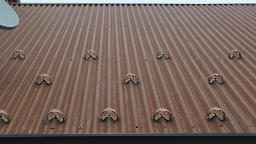 CorGard Snow Guard pattern on corrugated metal roof - below close-up