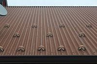 CorGard Snow Guard pattern on corrugated metal roof - below close-up